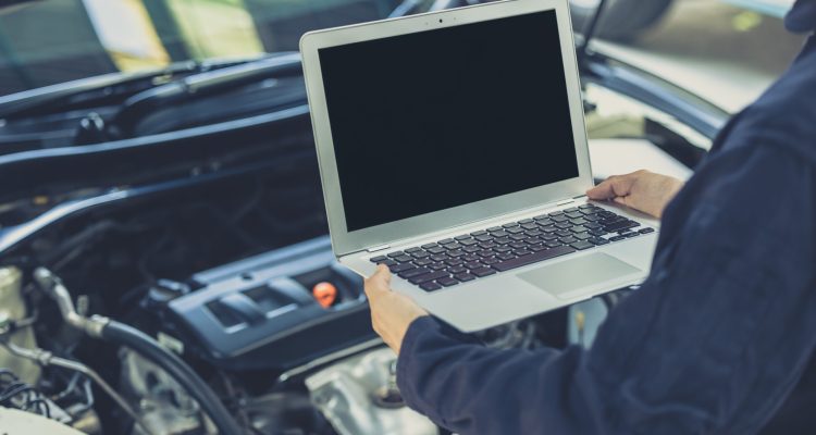 laptop computer blank screen with modern car engine performance ECU tune up in auto garage workshop concept ECU Programming Service